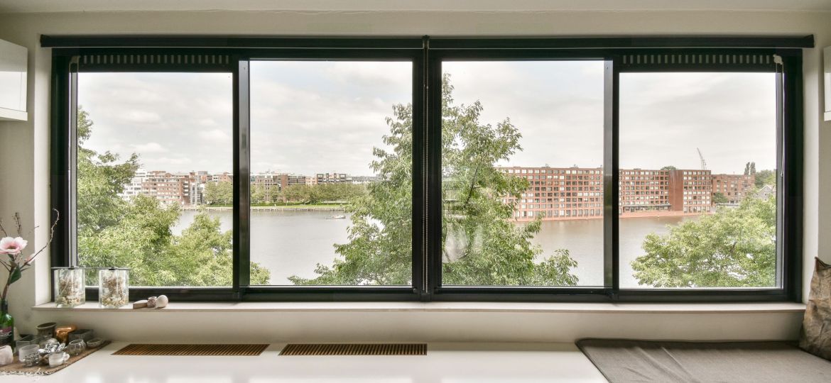 a kitchen with a view of a river and buildings